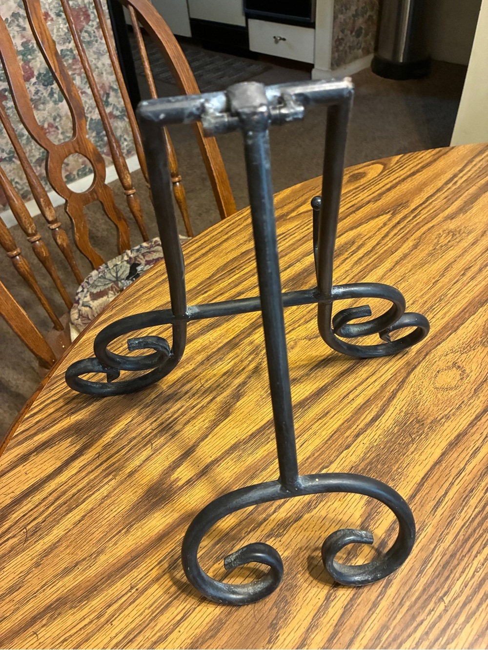 black metal table top easel features an intricate scroll work design - Picture 4 of 6
